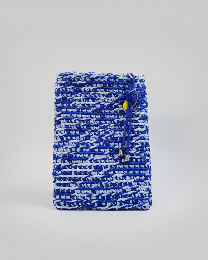 Blue and white patterned drawstring pouch on a gray background