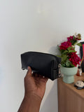 Hand holding a black leather pencil pouch 