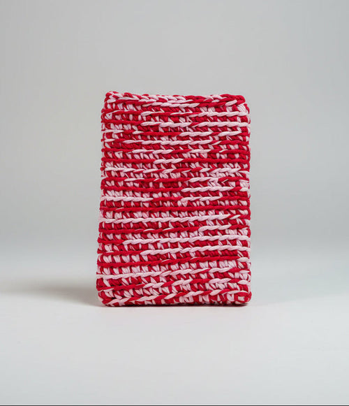 Red and pink patterned fabric laptop sleeve.